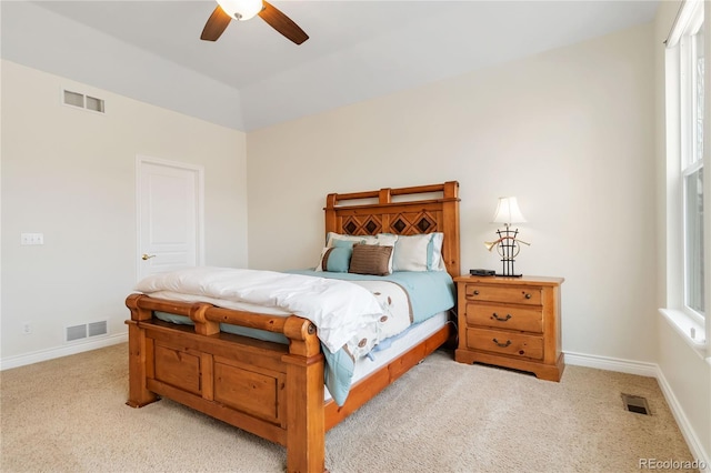 bedroom with light carpet, visible vents, and baseboards