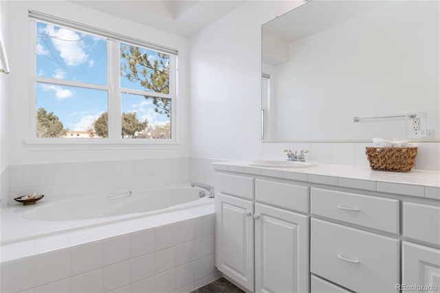 bathroom featuring vanity and a bath