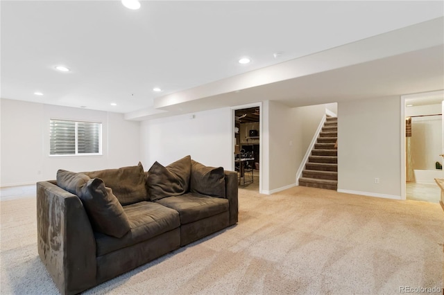 living room with baseboards, stairway, light carpet, and recessed lighting