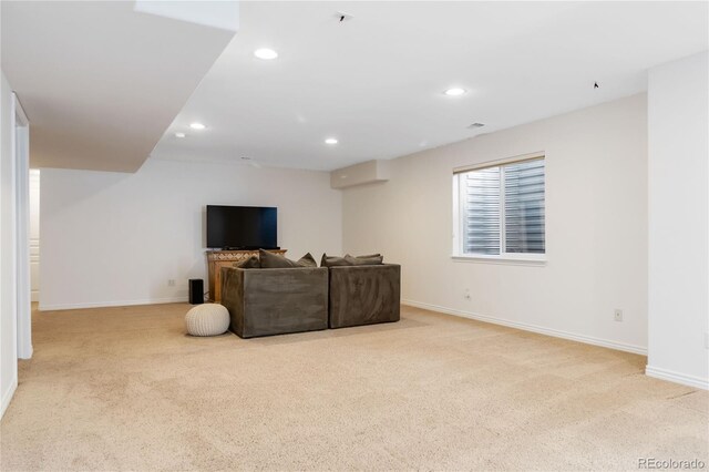 living area with light carpet, baseboards, and recessed lighting