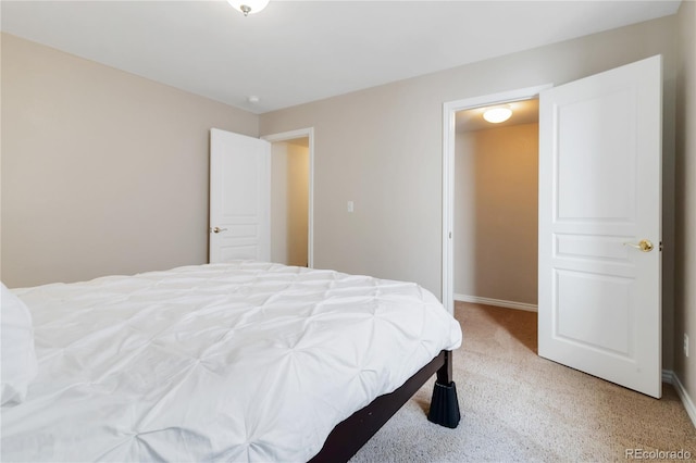 bedroom featuring light carpet and baseboards