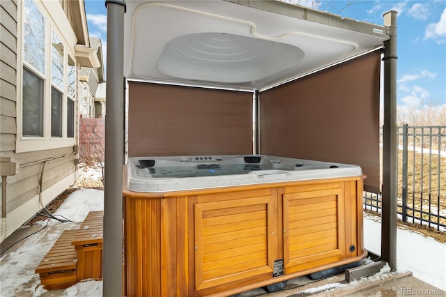 view of patio / terrace with fence and a hot tub