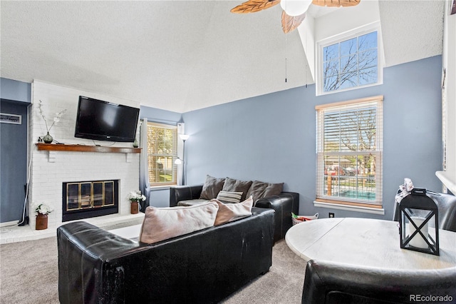 carpeted living area with ceiling fan and a brick fireplace