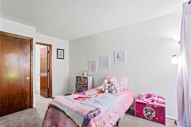 bedroom featuring a textured ceiling, baseboards, and carpet