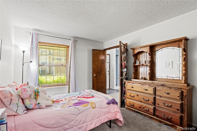 bedroom with carpet flooring and a textured ceiling