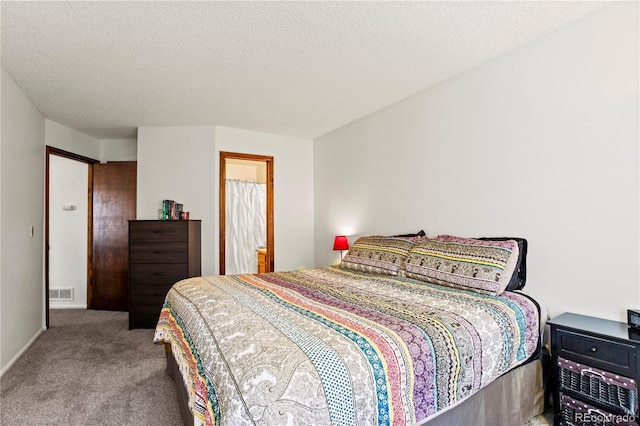 carpeted bedroom with a textured ceiling and visible vents