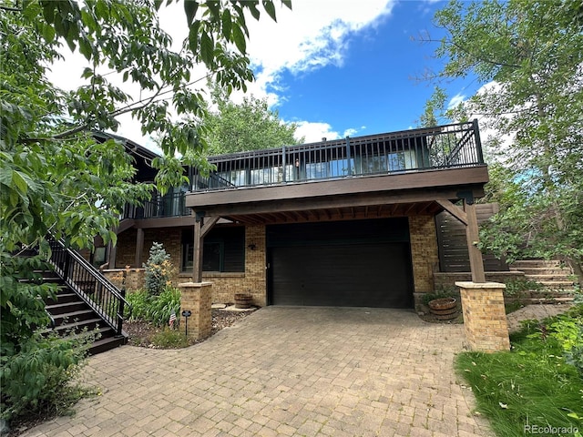 7454 Queen Cir, Arvada, CO 80005 - view of front property featuring stairs, a garage, brick siding, and decorative driveway