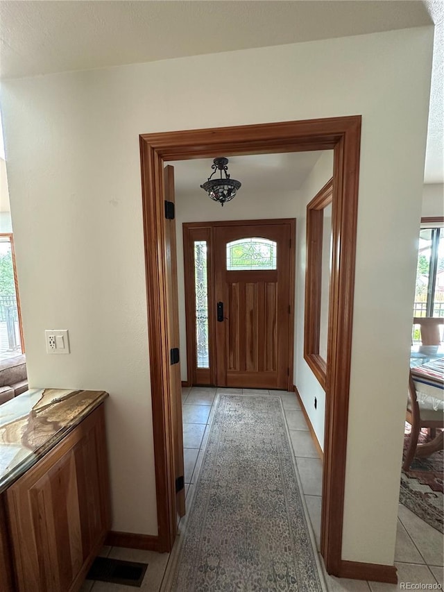 7454 Queen Cir, Arvada, CO 80005 - foyer entrance featuring light tile patterned floors and baseboards