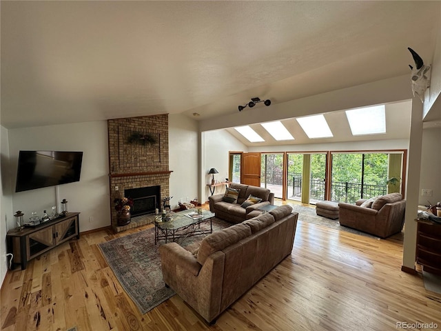 7454 Queen Cir, Arvada, CO 80005 - living room featuring lofted ceiling, light wood-style flooring, and a fireplace