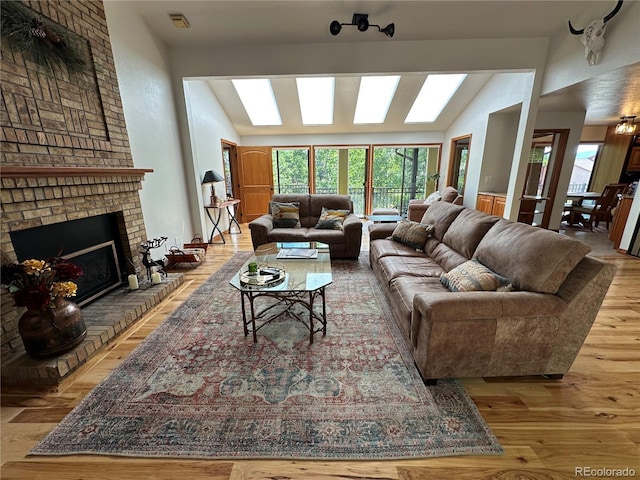 7454 Queen Cir, Arvada, CO 80005 - living room with vaulted ceiling, wood finished floors, and a fireplace