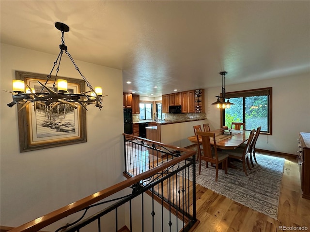 7454 Queen Cir, Arvada, CO 80005 - dining space featuring a chandelier, light wood finished floors, plenty of natural light, and recessed lighting