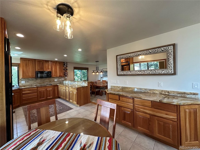 7454 Queen Cir, Arvada, CO 80005 - kitchen with black appliances, brown cabinetry, a peninsula, light tile patterned floors, and recessed lighting