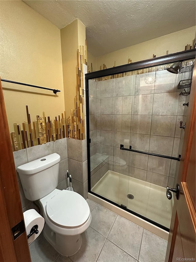 7454 Queen Cir, Arvada, CO 80005 - full bath with a textured ceiling, a shower stall, and tile patterned floors