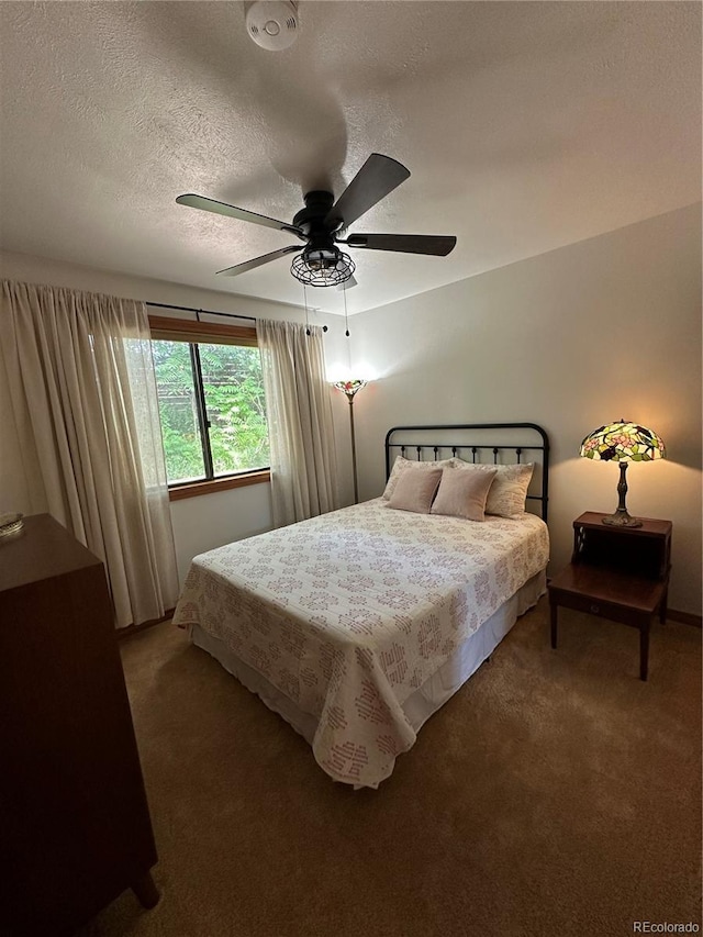 7454 Queen Cir, Arvada, CO 80005 - bedroom featuring light carpet, a textured ceiling, and a ceiling fan