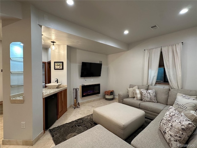 7454 Queen Cir, Arvada, CO 80005 - living room with recessed lighting and a glass covered fireplace