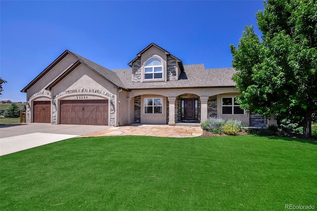 view of front of house with a front yard and a garage