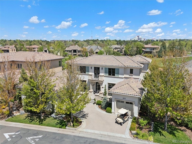 9171 E Harvard Ave, Denver, CO 80231 - mediterranean / spanish-style house with a balcony, a tile roof, stucco siding, a residential view, and a garage