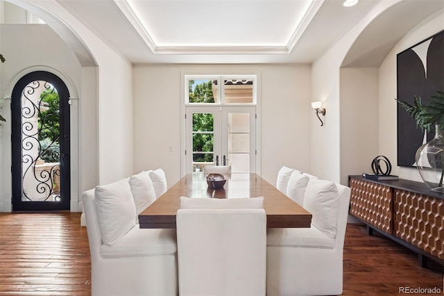 9171 E Harvard Ave, Denver, CO 80231 - dining space with a tray ceiling, wood finished floors, and arched walkways