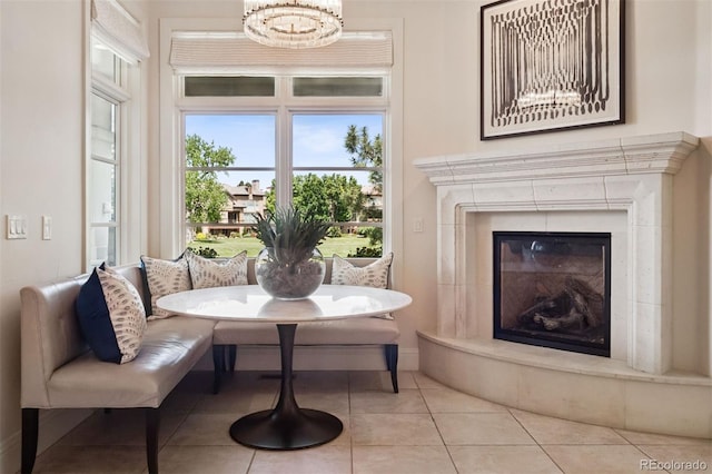 9171 E Harvard Ave, Denver, CO 80231 - dining space with breakfast area, a high end fireplace, a chandelier, and tile patterned floors