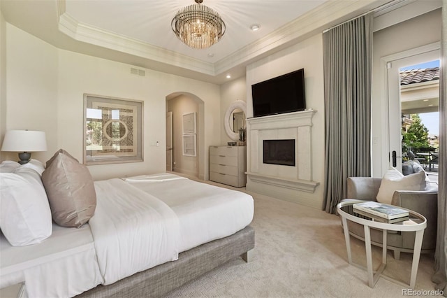 9171 E Harvard Ave, Denver, CO 80231 - bedroom with ornamental molding, arched walkways, carpet floors, a chandelier, and a fireplace with raised hearth