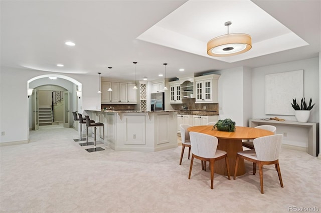 9171 E Harvard Ave, Denver, CO 80231 - dining area featuring recessed lighting, light colored carpet, arched walkways, and stairs