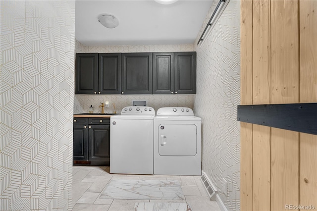 laundry room featuring baseboards, marble finish floor, cabinet space, and washing machine and clothes dryer