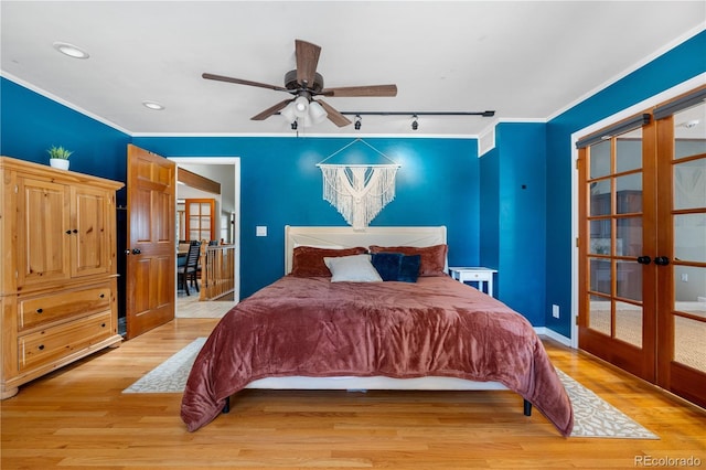 bedroom featuring french doors, rail lighting, light wood finished floors, ornamental molding, and recessed lighting
