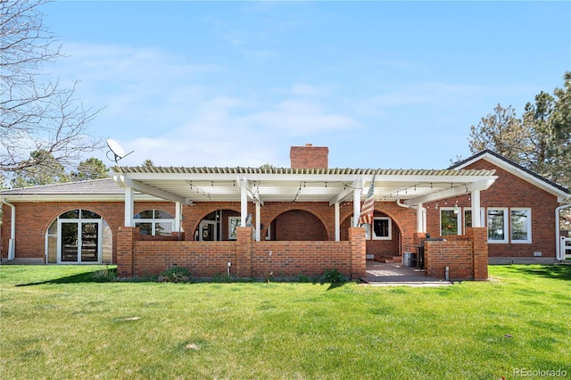rear view of house featuring a lawn, a pergola, a chimney, and brick siding