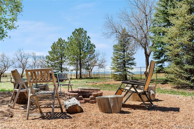 view of yard featuring a fire pit and fence