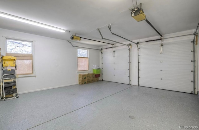 garage with baseboards and a garage door opener