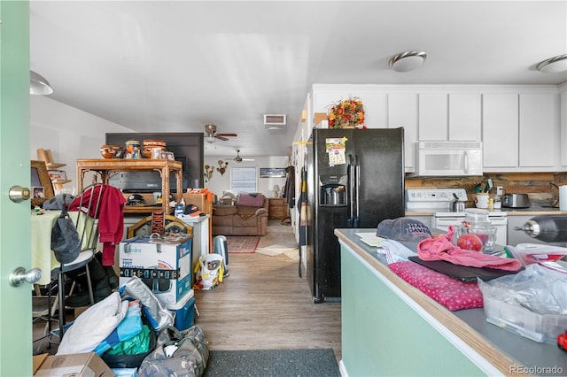 kitchen featuring a ceiling fan, visible vents, wood finished floors, white appliances, and white cabinetry