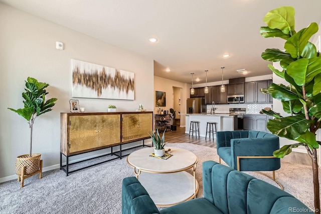 living room featuring baseboards and recessed lighting