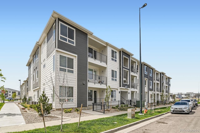 view of building exterior with fence and a residential view
