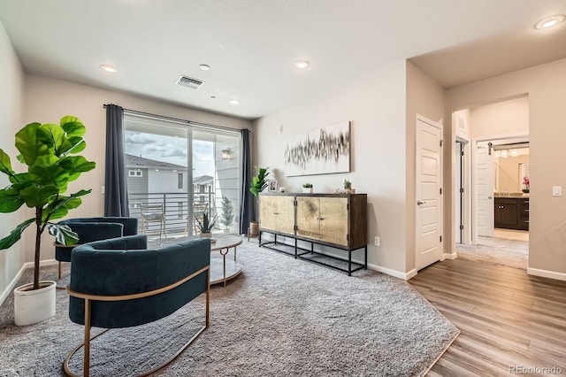 living area featuring baseboards, recessed lighting, visible vents, and wood finished floors