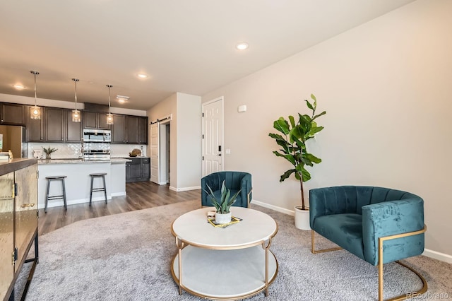living room featuring baseboards, dark wood-style floors, and recessed lighting