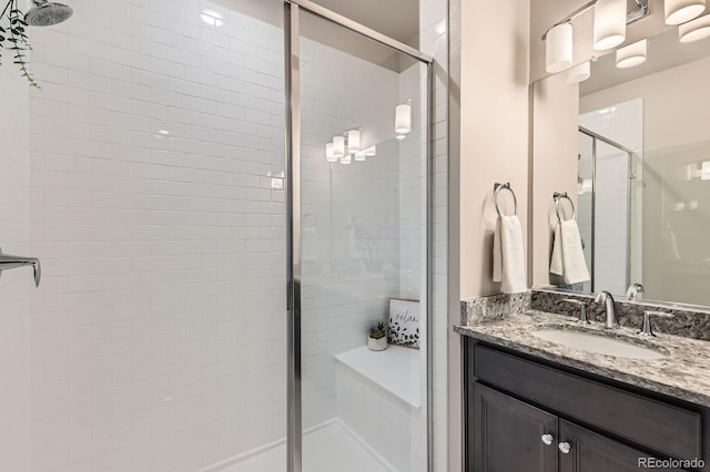 full bathroom with vanity and a stall shower