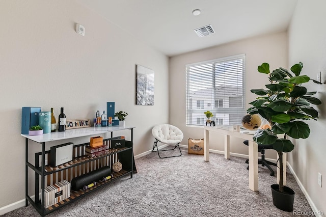 interior space featuring baseboards, visible vents, and carpet floors