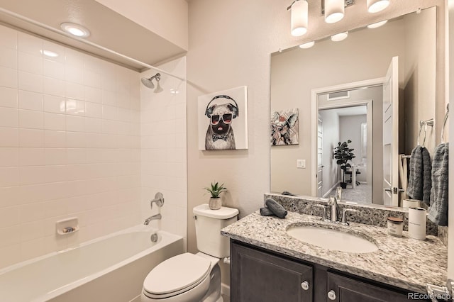 bathroom with shower / bath combination, vanity, and toilet