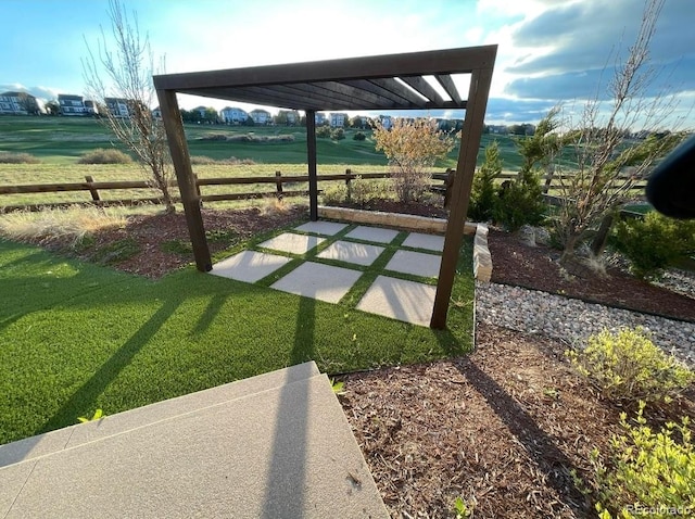 view of yard featuring a pergola, a patio area, and a rural view