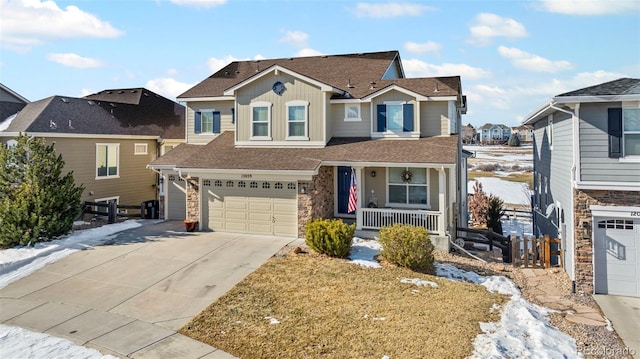 view of property with a garage and covered porch