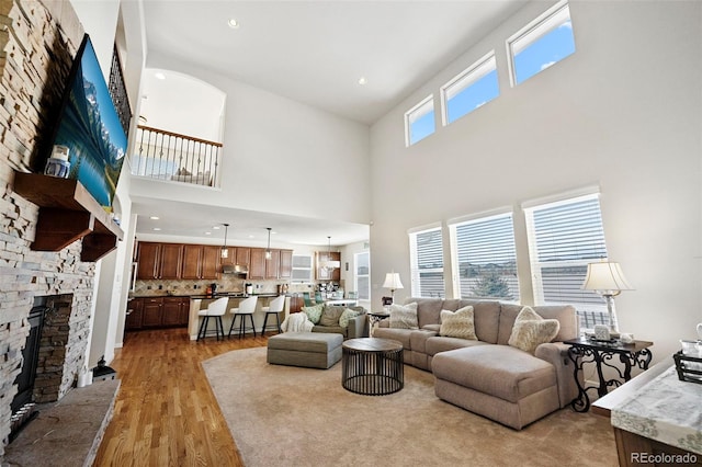 living room with a fireplace and light wood-type flooring