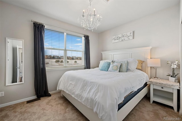 carpeted bedroom featuring a notable chandelier