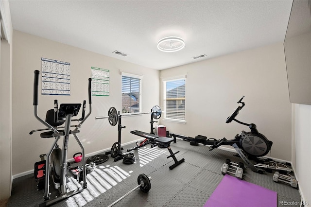 workout room with a textured ceiling