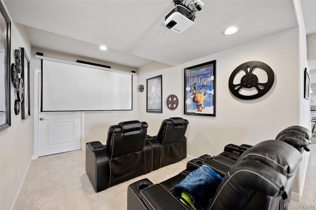 home theater room featuring light carpet and a textured ceiling