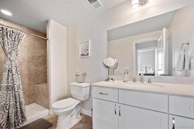 bathroom with vanity, tile patterned flooring, toilet, and walk in shower