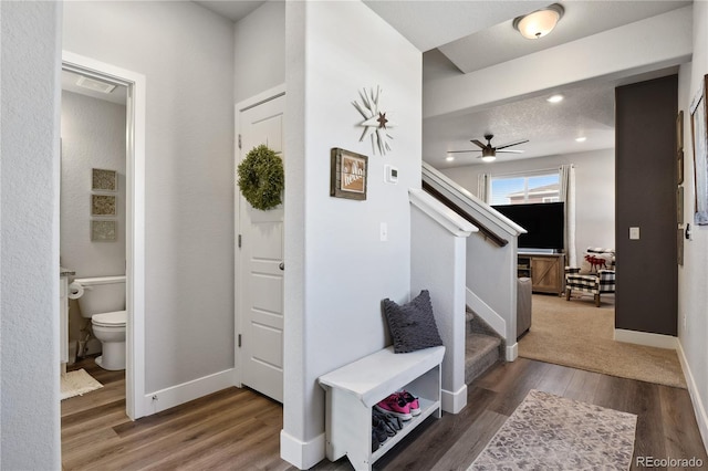 foyer featuring wood finished floors, recessed lighting, baseboards, ceiling fan, and stairs