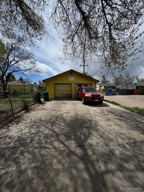 exterior space featuring fence and a garage