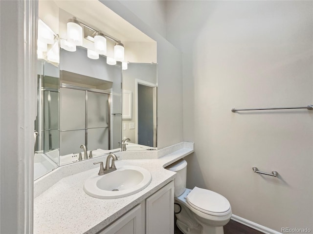 bathroom with vanity, toilet, and walk in shower