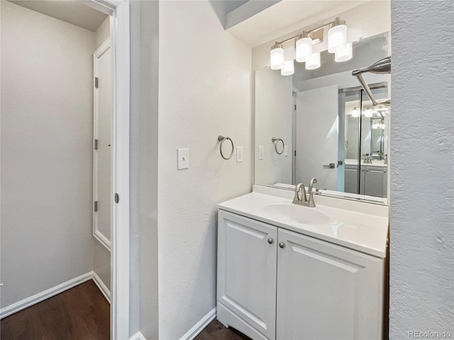 bathroom with hardwood / wood-style floors and vanity