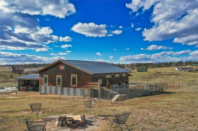 exterior space featuring an outbuilding and a rural view